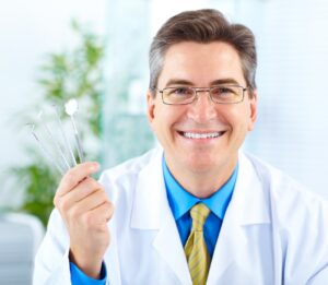 Smiling,Dentist,With,Tools,In,The,Office