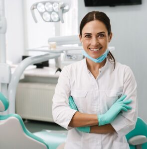 European,Mid,Dentist,Woman,Smiling,While,Standing,In,Dental,Clinic