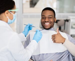 Happy,Black,Male,Patient,Showing,Thumb,Up,While,Having,Check