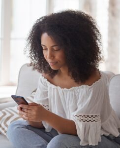 Smiling,Afro,American,Woman,Enjoying,Using,Smartphone,Application,Reading,Positive